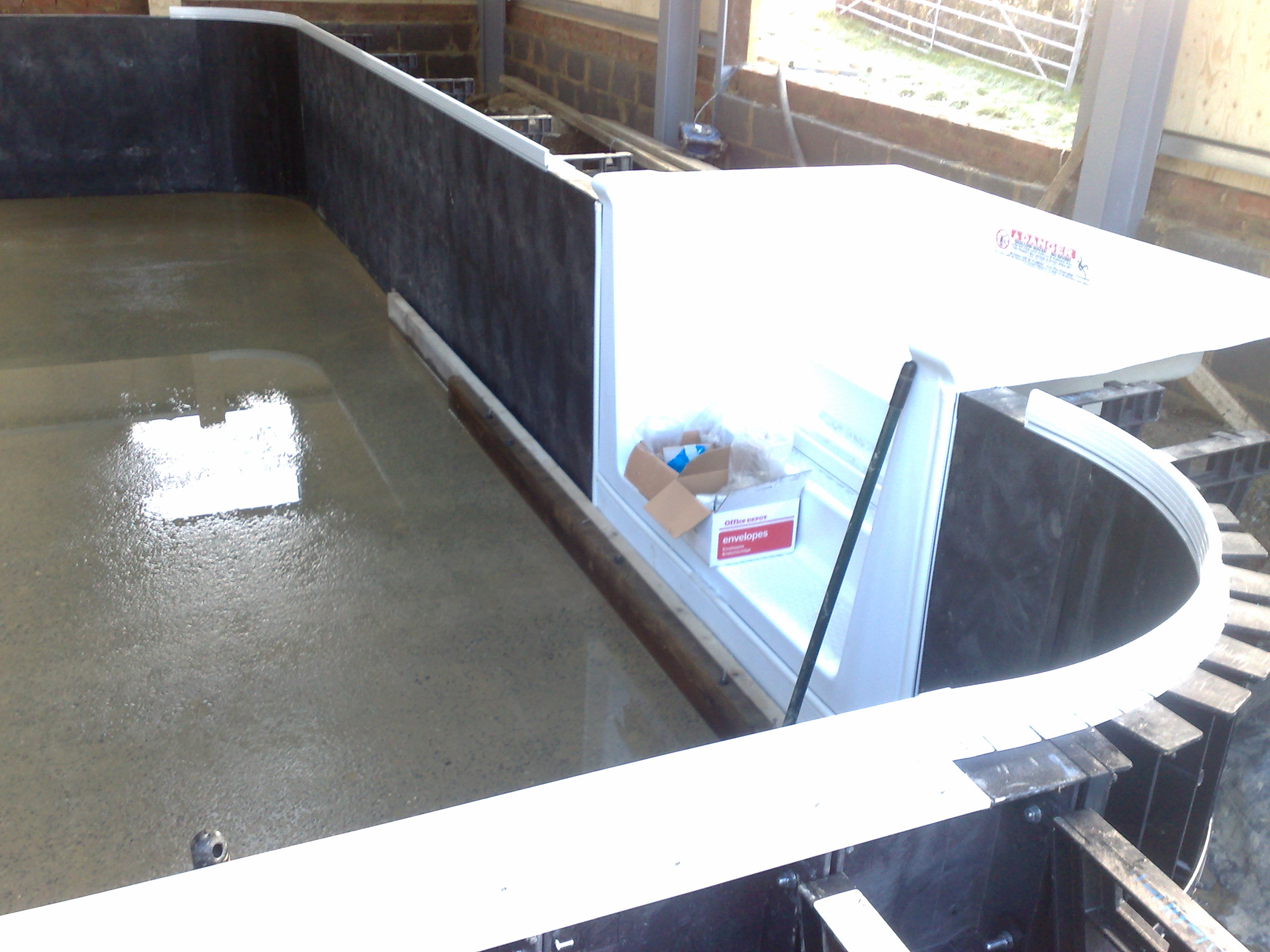 Kafko Polymer Panel swimming pool under construction - Aluminium coping