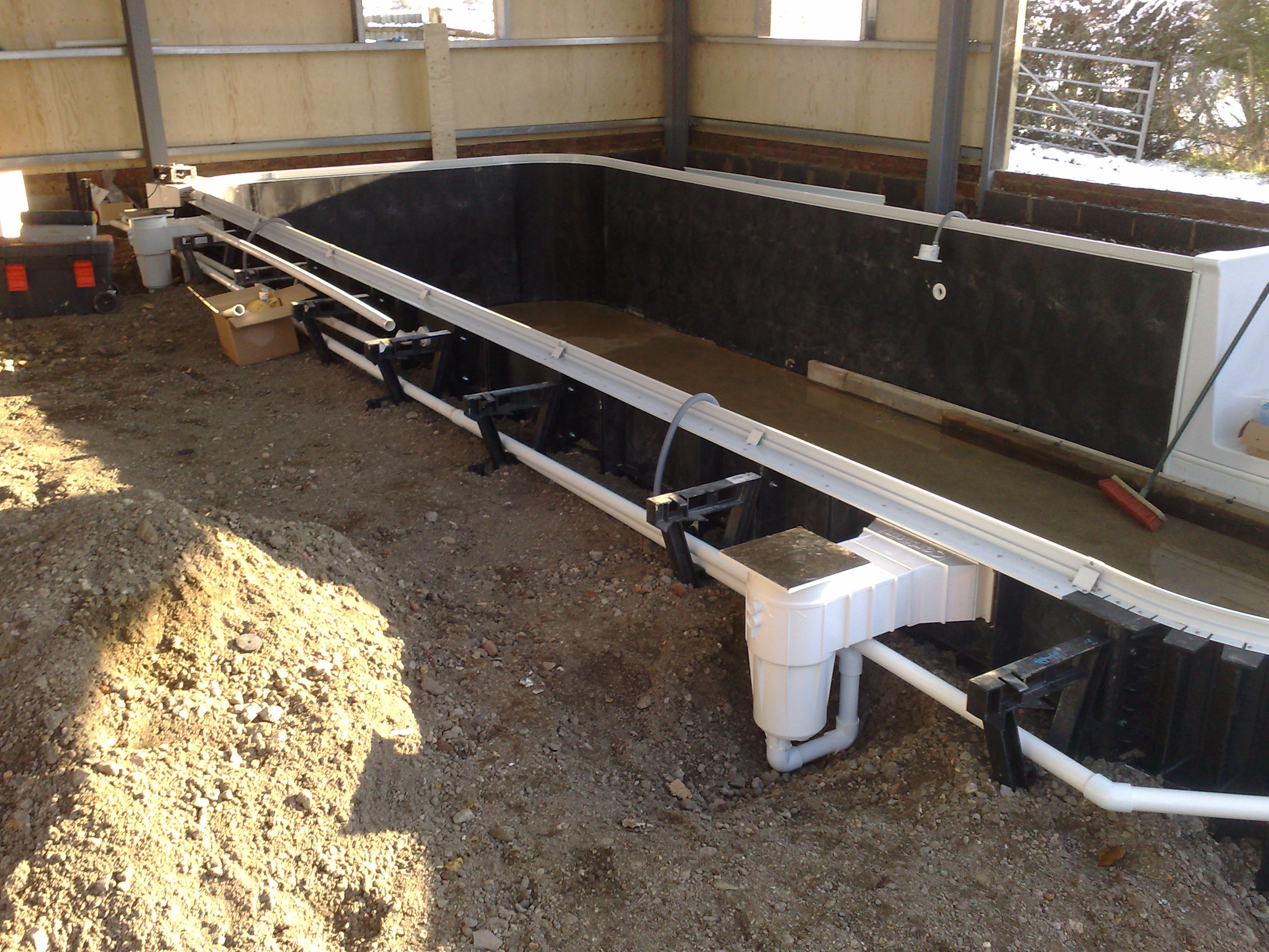 Kafko Polymer Panel swimming pool under construction - skimmer and pipework